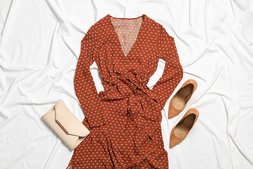 a rust colored patterned dress teamed with tan pumps and purse