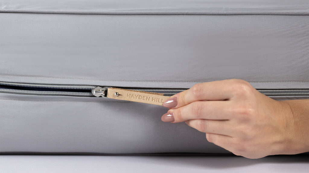 Woman unzipping the Gray Organic Cotton Storage Bag