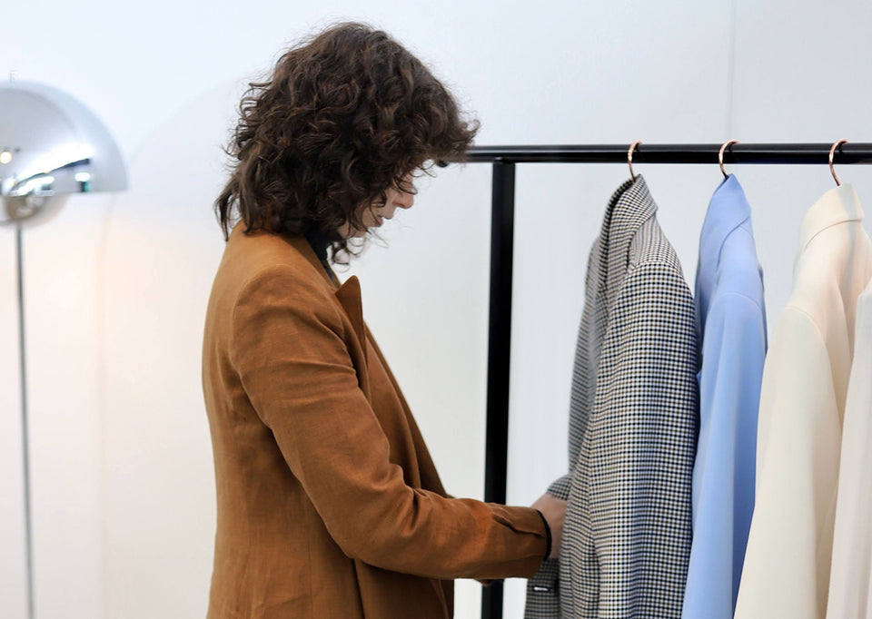 Jenna selecting jackets for a shoot she is styling