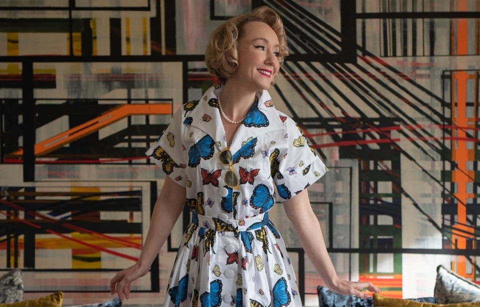 Phoebe wearing a sustainably made organic cotton dress with a butterfly print