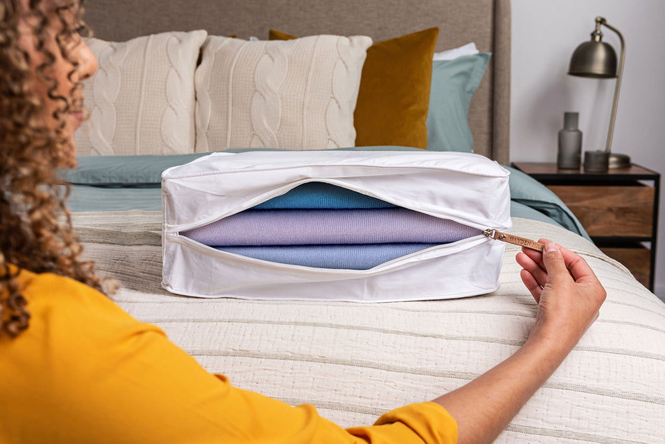 a close up of an open Hayden Hill Storage Bag with sweaters stored inside