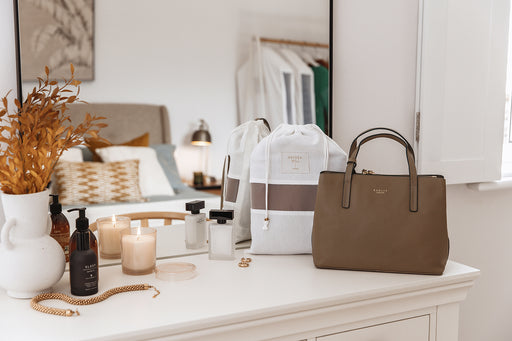 a dressing room table with a handbag and a Hayden Hill dust bag