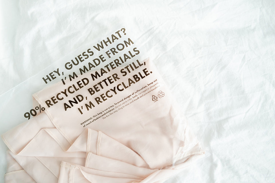 a shirt made of recycled materials packed in a recyclable bag