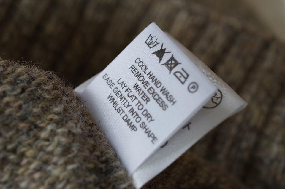 a close up of a care label for cashmere wool which instructs a cool hand wash