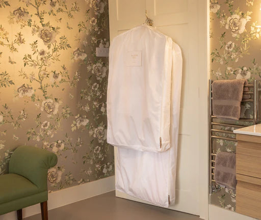 a short and long Hayden Hill organic cotton garment bag hanging from a door