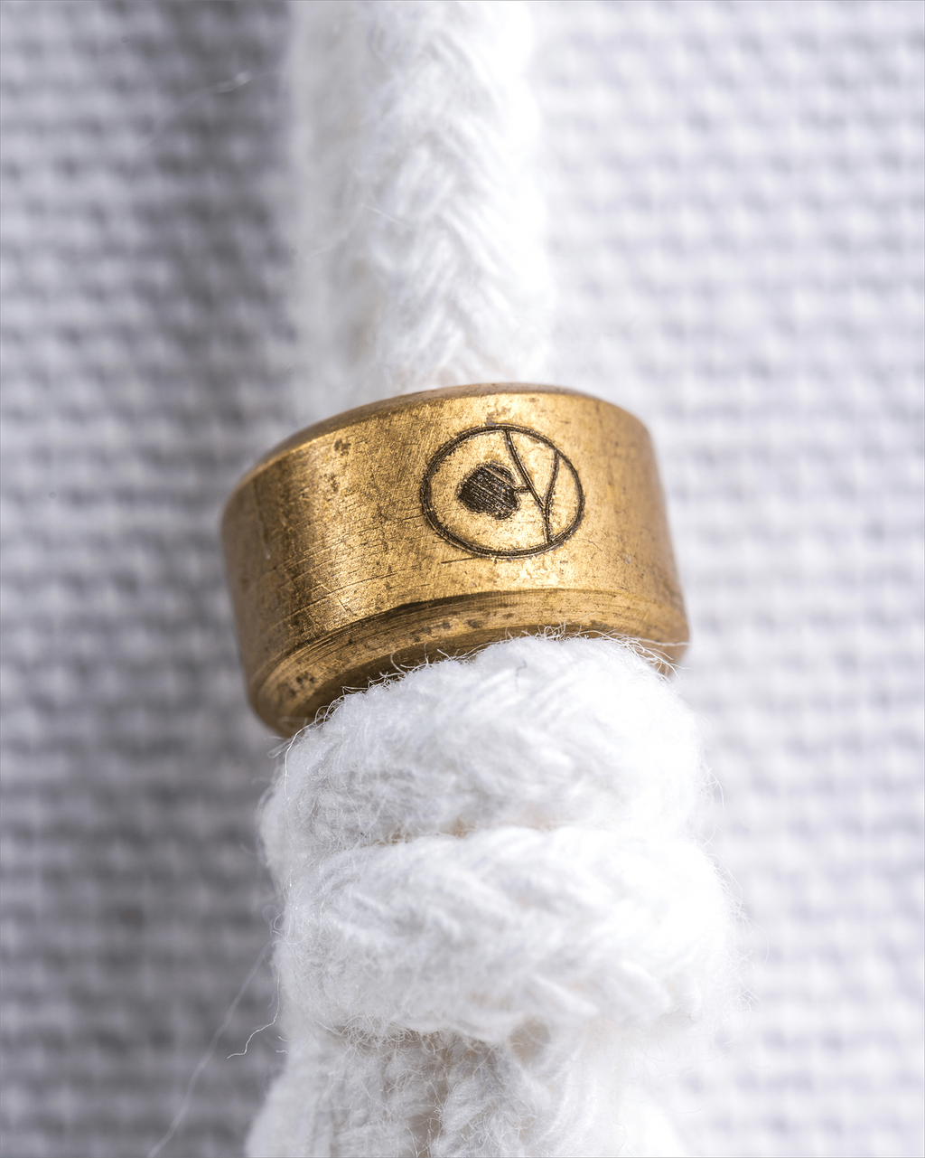 a close up of one of the brass sliders  on a dust bag