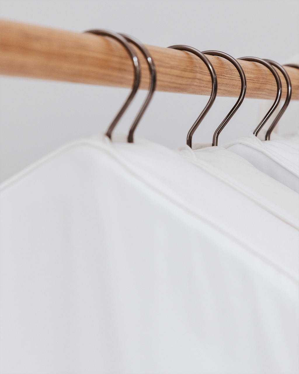 a close up of the overlapped hanger opening on some hanging garment bags which reduces clothes moth access