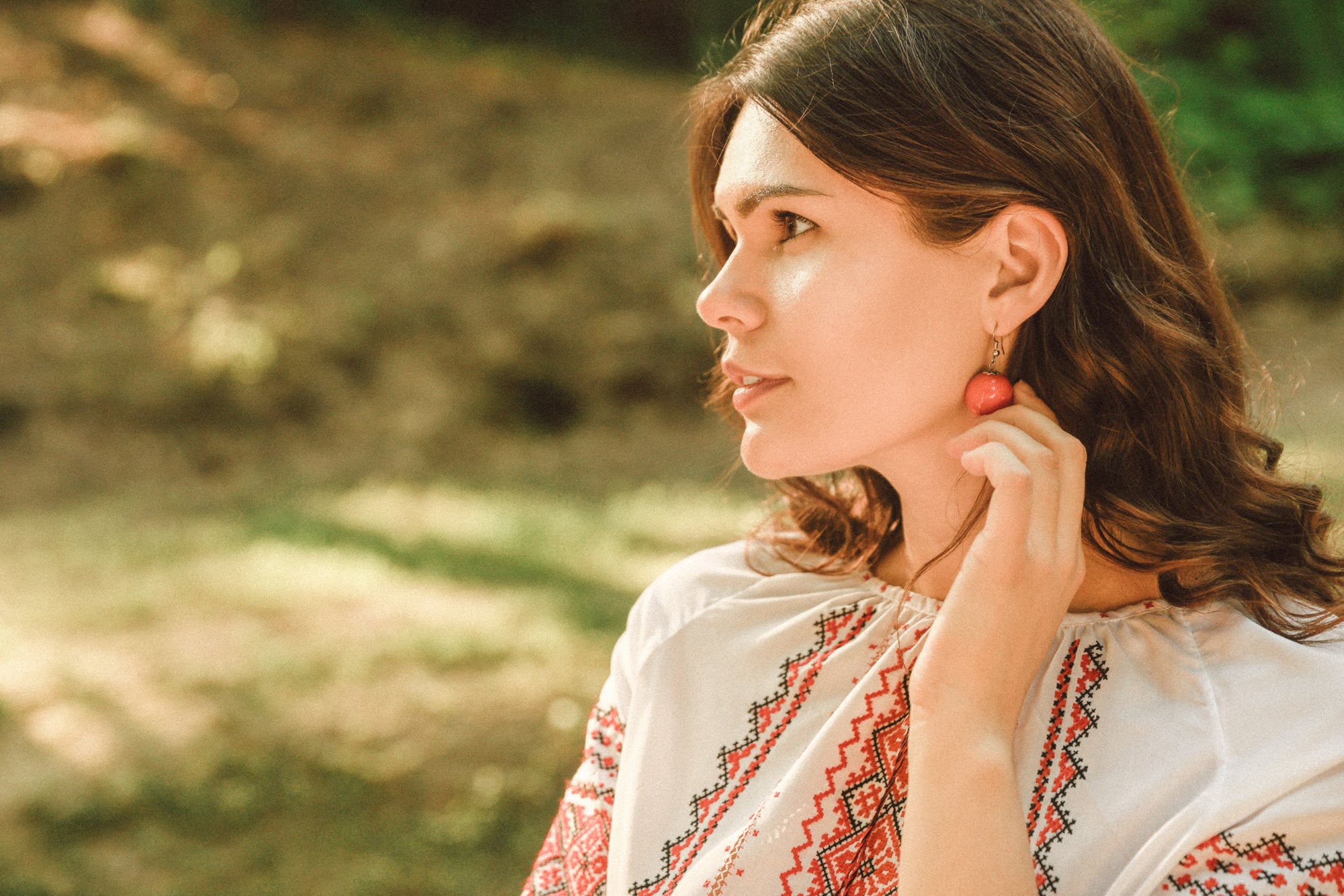 a beautiful woman wearing an embroidered top