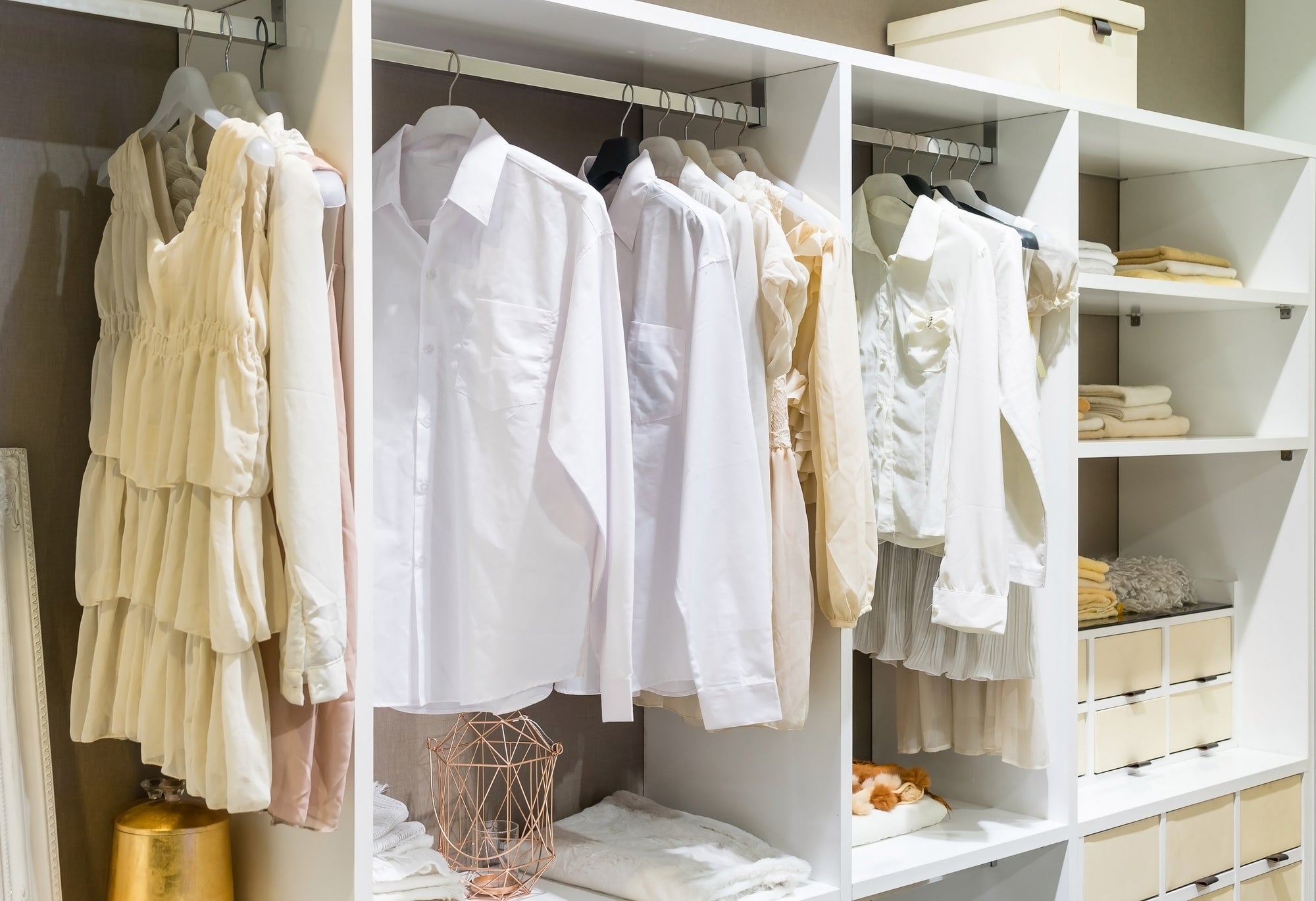 a closet full of shirts and short dresses in spring colours