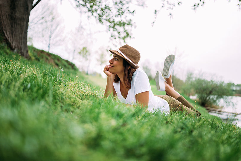 a woman lying on her front on fresh green grass