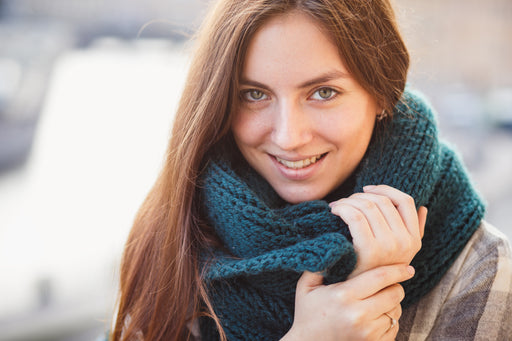 a woman with a thick woollen scarf wrapped around her