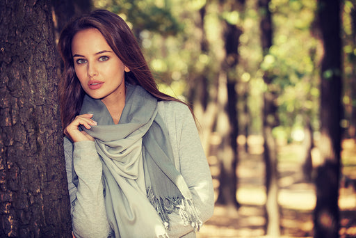 a beautiful woman wearing a soft grey scarf