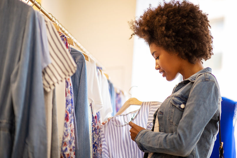 a woman shopping for clothes in a store