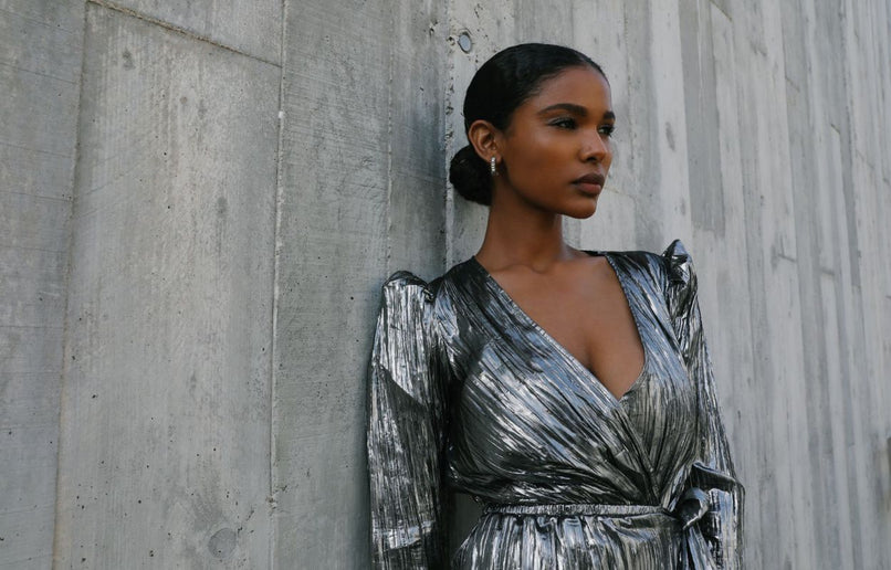 a woman wearing a stunning metallic silver dress