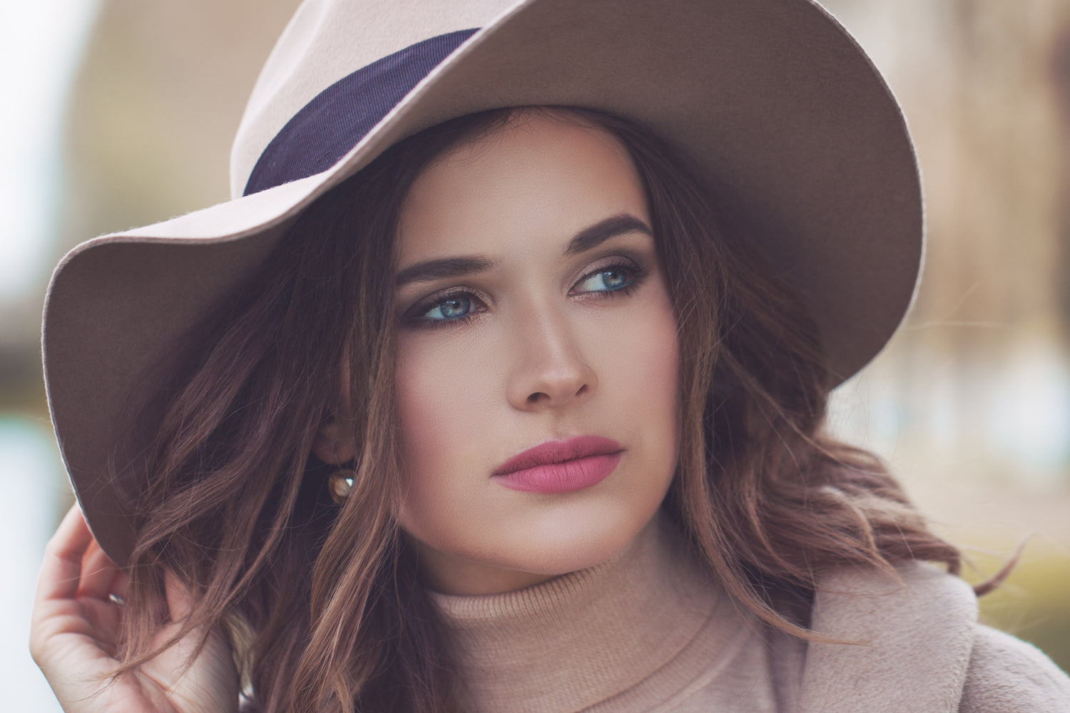 beautiful woman in a cashmere roll neck and felt fedora