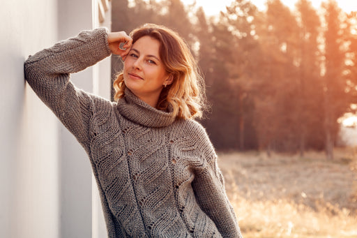 woman relaxing outdoors in a cozy gray cashmere sweater