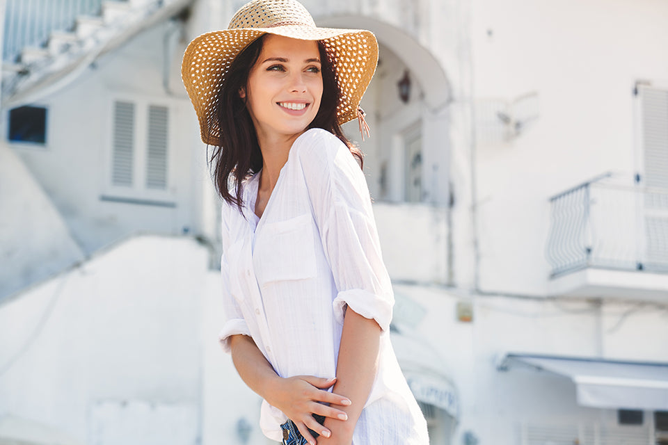 a woman wearing a floppy straw hat