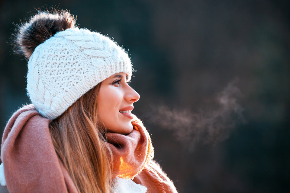 a woman wearing a cashmere scarf and woolen hat