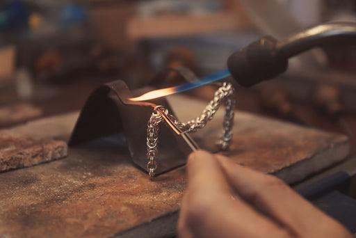 a chain being soldered by a jeweler