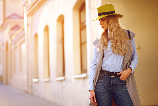 a fashionable woman wearing a yellow straw trilby