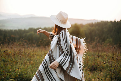 a woman wearing a striped woolen poncho