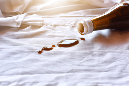 a spilt sauce bottle on a piece of white clothing
