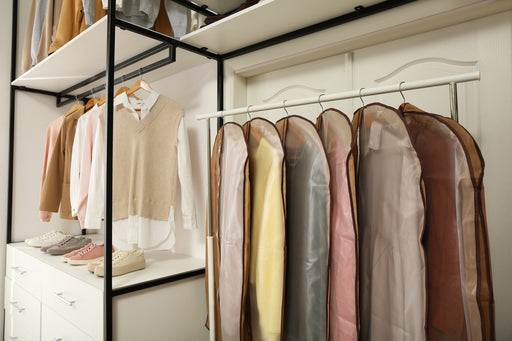 an arrangement of clothing hanging  in garment bags