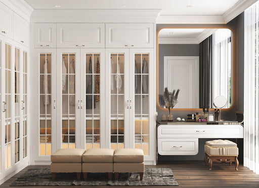 a stunning walk-in closet with mirrored cupboards and seating