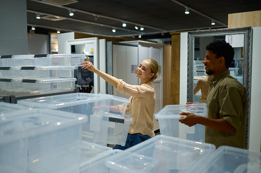 a couple choosing transparent storage containers from a store