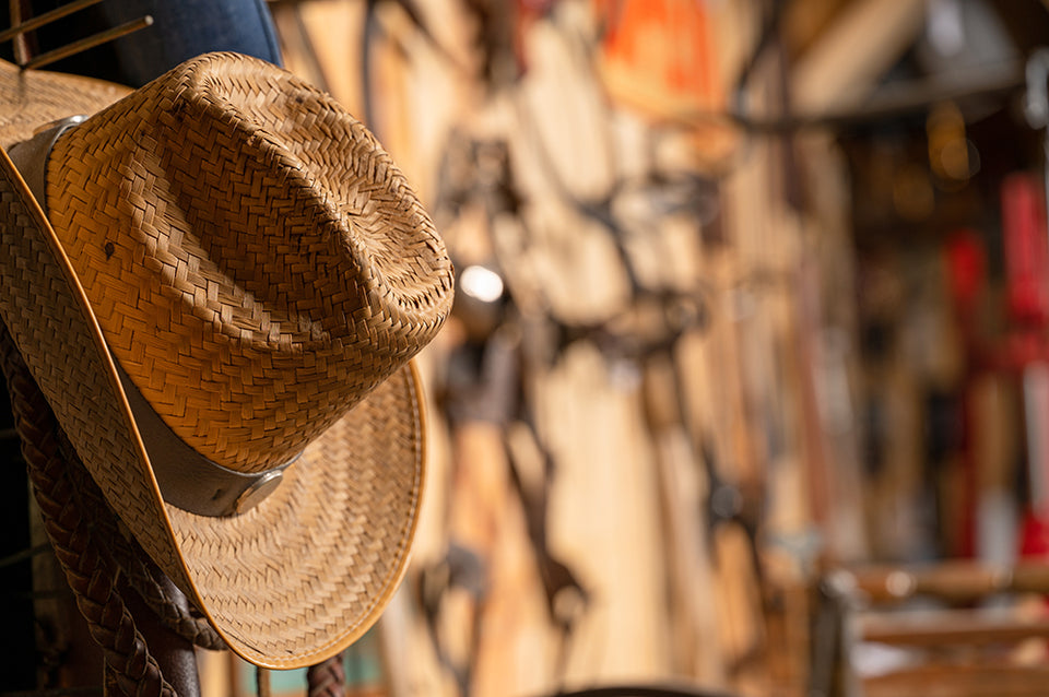 a cowboy hat hanging on a wall