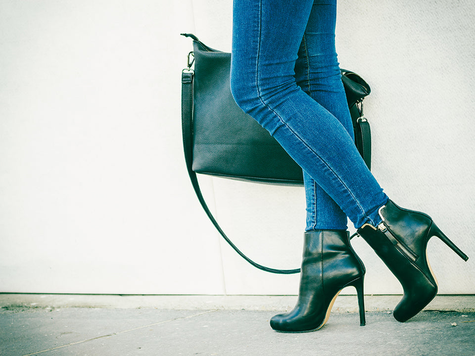 a pair of high heeled green leather ankle boots with matching bag