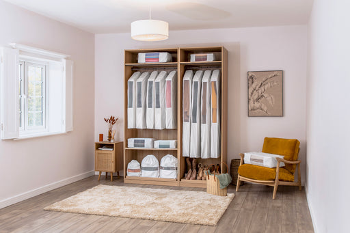 a beautifully organized closet packed full with Hayden Hill garment bags packing cubes and dust bags