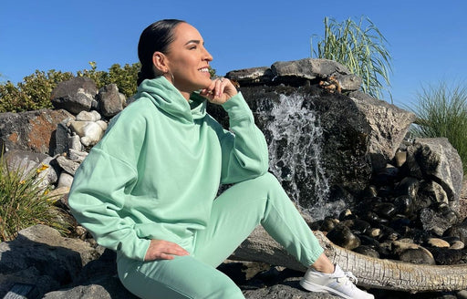 Riquel enjoying the sunshine wearing a Fabletics pale green hoodie and track pants