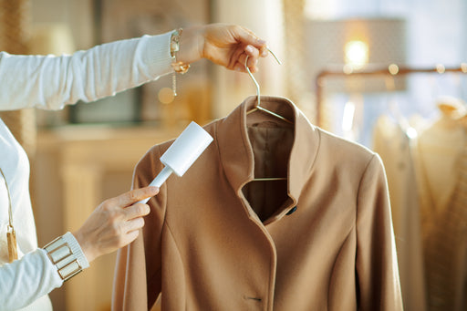 a camel cashmere coat with a lint roller