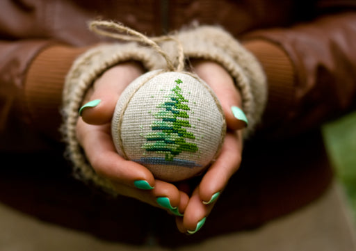 a christmas tree bauble made from embroidered fabric