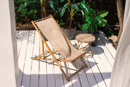 a deck chair and table made out of bamboo