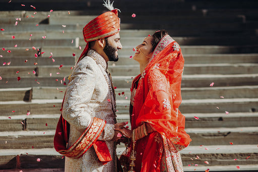 a groom and his bride in traditional Indian wedding dress