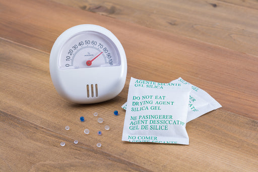 a hygrometer and some silica gel packets
