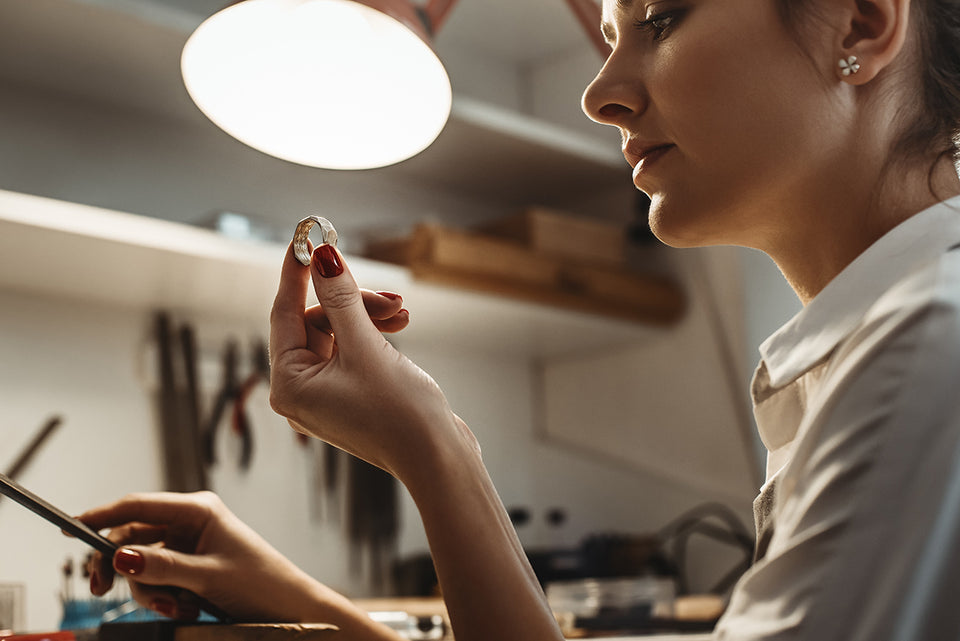 a jeweler making a silver ring