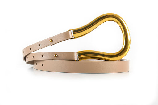 a narrow leather belt with large gold loop buckle