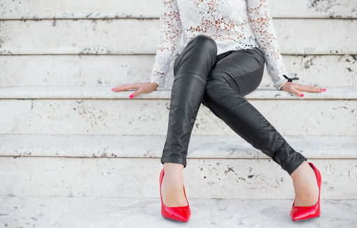 a pair of black leather leggings teamed with a lacy white top and bright red heels