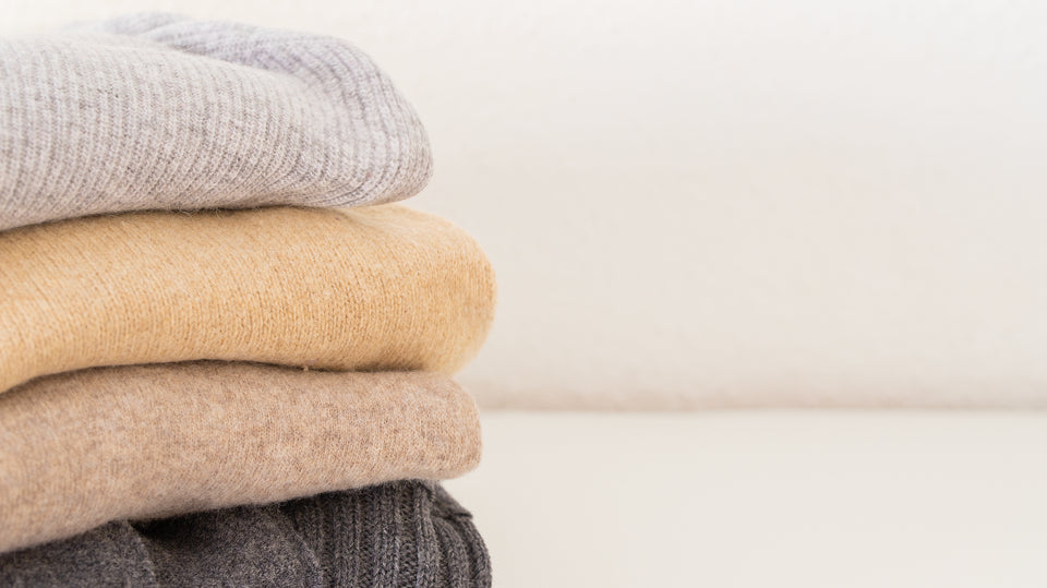 a pile of cashmere sweaters