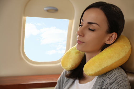 a relaxed woman using her travel pillow