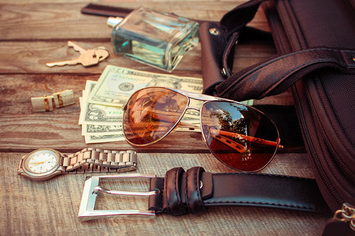 a selection of accessories including a belt, watch, cufflinks and sunglasses