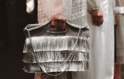 a silver fringed handbag being modeled on the catwalk