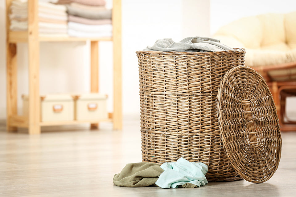 a wicker laundry basket with lid