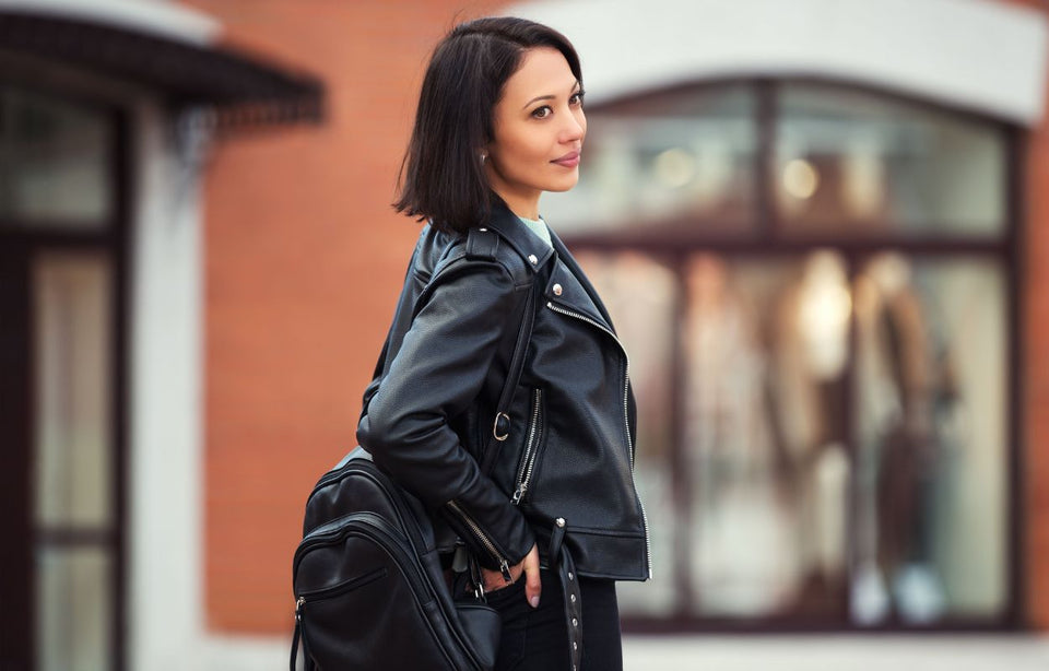 a woman wearing a black leather biker style jacket
