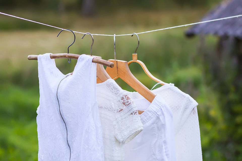 white clothing hanging on a clothes line being aired outdoors