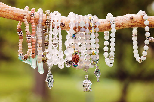 an assortment of assembled bracelets made from beads and charms