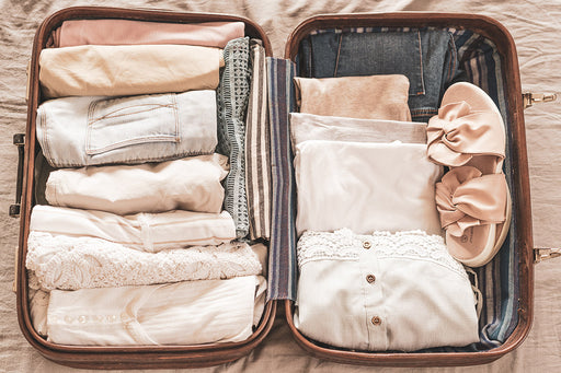 an open suitcase packed with rolled items